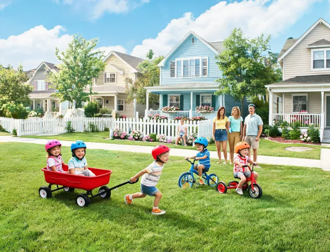 Neighborhood family play day with wagons and tricycles